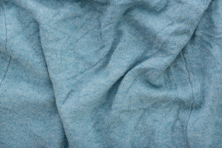Close up of old dirty wrinkled cyan bedsheet fabric texture background.の写真素材