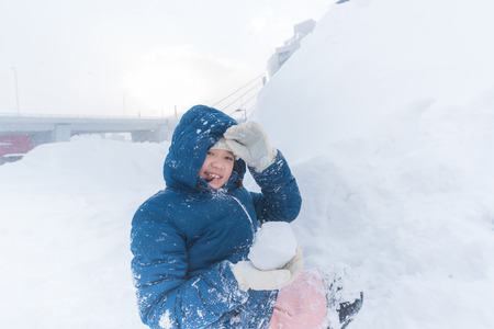 Close up of cute happy asian girl playing snow in winter Aomori Japan.の写真素材