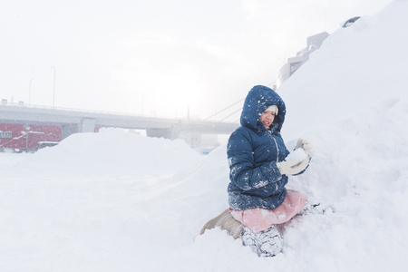Close up of cute happy asian girl playing snow in winter Aomori Japan.の写真素材