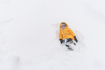 Close up of cute happy asian boy playing snow in winter Aomori Japan.の写真素材