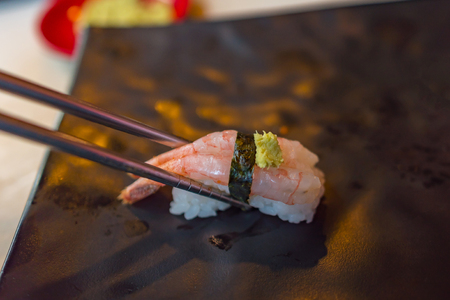 Close up of japan sushi called ama ebi nigiri contain with rice seaweed or nori and sweet shrimp in local restuarant.の写真素材
