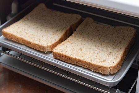 Close up of fresh organic sliced bread in the oven for healty breakfast.の写真素材