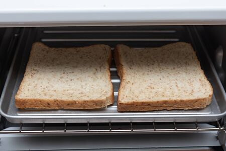 Close up of fresh organic sliced bread in the oven for healty breakfast.の写真素材