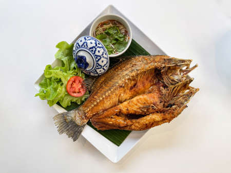 Thailand favorite menu deep fried fish called prakapong tod nam pla served with thai spicy topping...