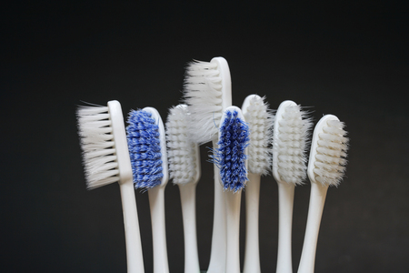 Worn out toothbrush on dark backgroundの写真素材