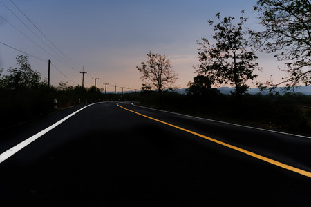 Country Road to the end with twighlight blue skyの写真素材