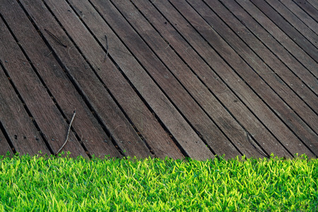 Wooden Floor in household with green grass. use to be background for put some stuff on wooden slat.の写真素材