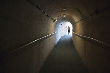 Okinawa, Japan - October 21, 2016: Hallway of Japanese Navy Underground Headquarters during world war II, Selective Focus and blurred at the end of tunnelのeditorial素材