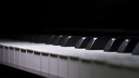 Close up Piano Keys background in low light toned, selective focusedの写真素材