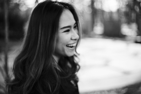 Blurred Portrait of Young Asian Woman laughing in vintage mono tone film.の写真素材