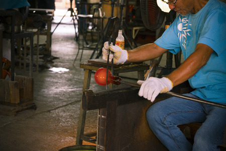 Unidentified Man forming a hot glass at Ryukyu Glass Villageのeditorial素材