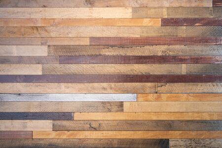 Various tone of wooden stripes use as wall partition or fence cladding in horizontal line which also...