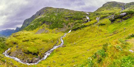 a small river flows downhill in a mountain in norwayの写真素材