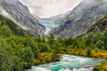 landscape of a glacier and a river from the melted water from the glacier in Norwayの写真素材