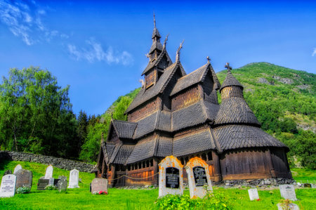traditional wooden church in Norway with the cemetery next to the church and the tombsの写真素材