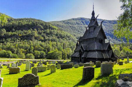 traditional wooden church in Norway with the cemetery next to the church and the tombsの写真素材