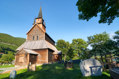 traditional wooden church in Norway with the cemetery next to the church and the tombsの写真素材