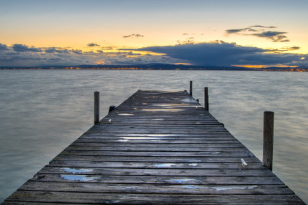 a wooden pier in the albufera lake in Valencia, Spain at sunsetの写真素材
