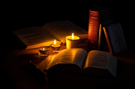 old books with candlelight in black backgroundの写真素材