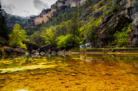 Clear and transparent water in a reservoir surrounded by mountains in Spainの写真素材