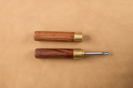 Edge Bevelers with wooden handle on brown leather. Bevels and rounds off edges of leatherの写真素材