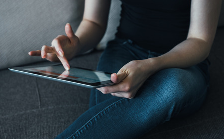 woman and tablet on sofa at homeの写真素材