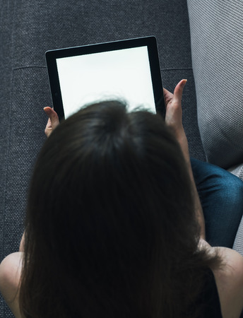 woman and tablet on sofa at homeの写真素材