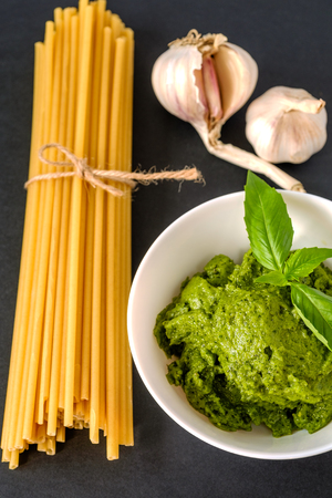 pasta garlic and Pesto sauce in a white plate on a black backgroundの写真素材