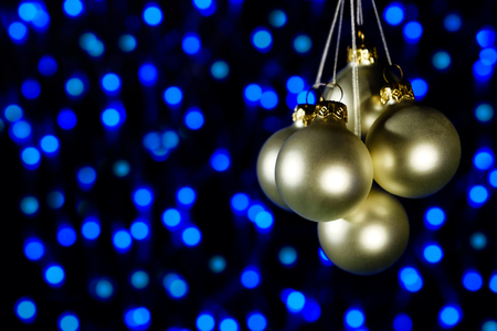 Christmas decoration balls on the background of blue lightsの写真素材