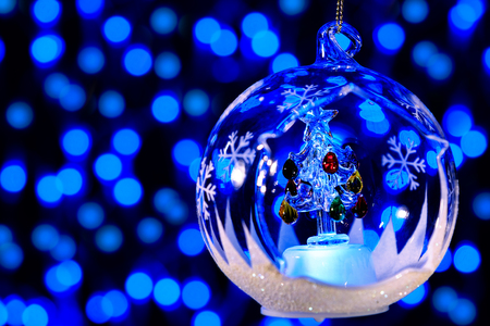 Christmas tree decoration ball on the background of blue lightsの写真素材