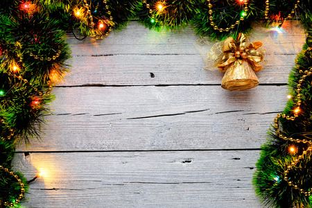 Christmas artificial fir tree branches with decorations on an white wooden background, copy space for text, top view.の写真素材