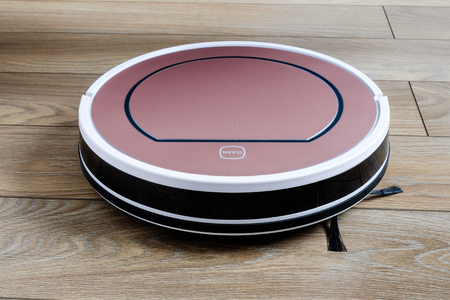 robotic vacuum cleaner on wood floor smart cleaning technologyの写真素材