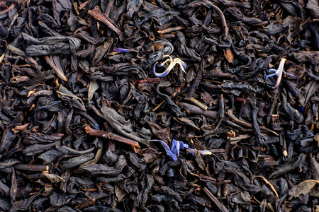 Dry tea with fruit and flower petals as background top viewの写真素材