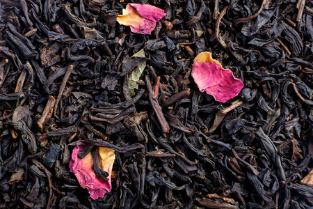 Dry tea with fruit and flower petals as background top viewの写真素材