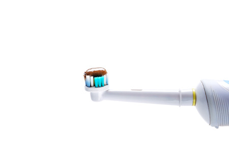 herbal toothpaste on electric toothbrush isolated on a white backgroundの写真素材