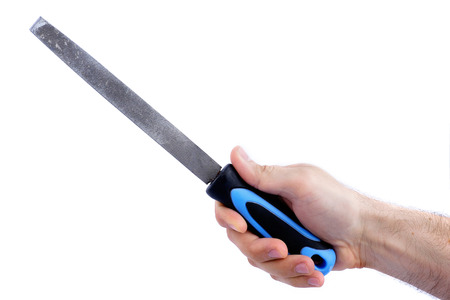 hand holding flat rasp hand tool isolated on a white backgroundの写真素材
