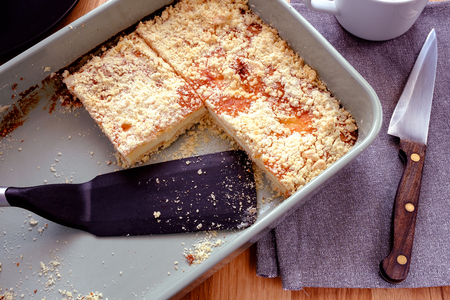 cottage cheese in a ceramic casserole form on a grey towel.の写真素材