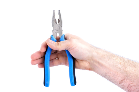 electric tool, man hand holding blue pliers isolated on white background close-upの写真素材