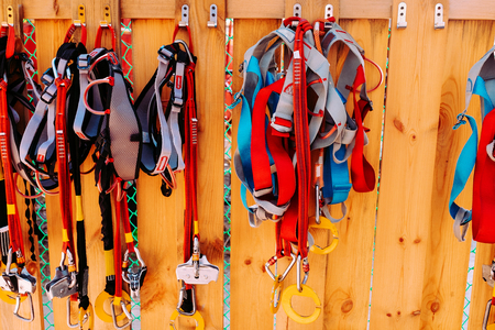 climbing equipment - carabiner, red, blue and black rope, on wood wall, outdoor workoutの写真素材