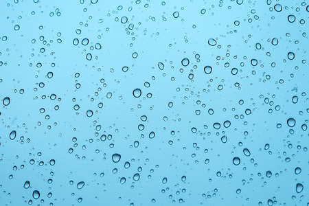 blue water drops on the glass backgroundの写真素材