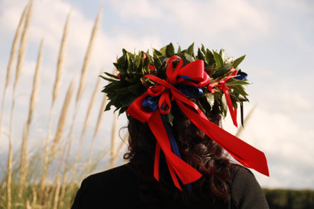 Woman with wreath of flowers and ribbons on her head for her graduation.の写真素材