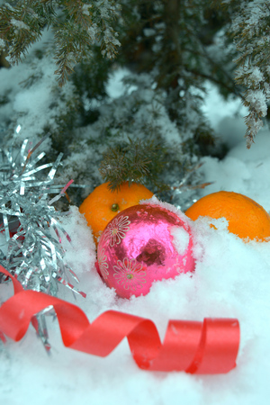 Christmas tree, toys and tangerine on the snowの写真素材