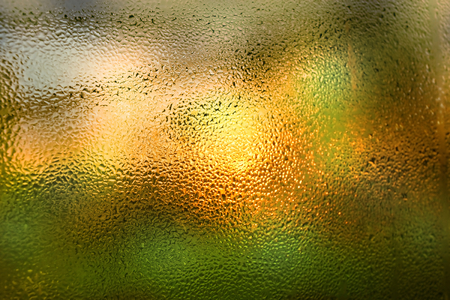 bright background with raindrops on window glassの写真素材