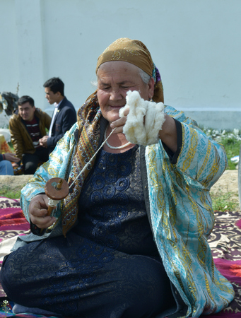 portrait of a grandmother spinning woolen yarnのeditorial素材