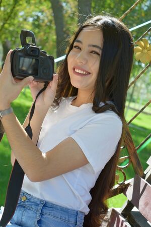 Beautiful young girl with a photo camera