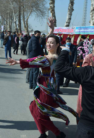 Jizzakh, Uzbekistan, March 2021. Spring Navruz holiday. Uzbek young women in national costumes at Navruz spring festival.のeditorial素材