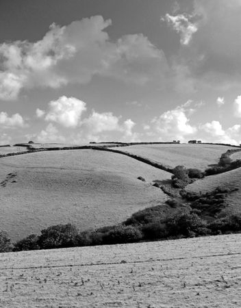 Beautiful rural view of rolling farm land and sky in Cornwall, UKの写真素材