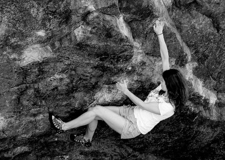 Keswick, The Lake District, Scotland, May 26th 2009, young woman climbing The Bowderstoneのeditorial素材
