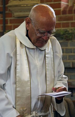 Goring, Berkshire, UK, 25th October 2009, a priest / vicar doing a christening serviceのeditorial素材