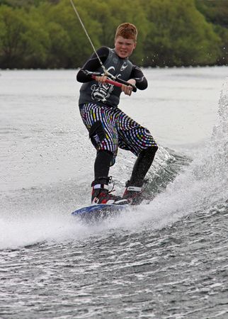 Heron Lake, Wraysbury, UK April 25th 2010 a young boy Wake Boarder / wakeboarding at the British Disabled Water Ski-ing Association BDWSAのeditorial素材